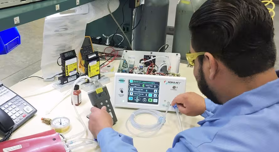 A technician repairs an electronic device.